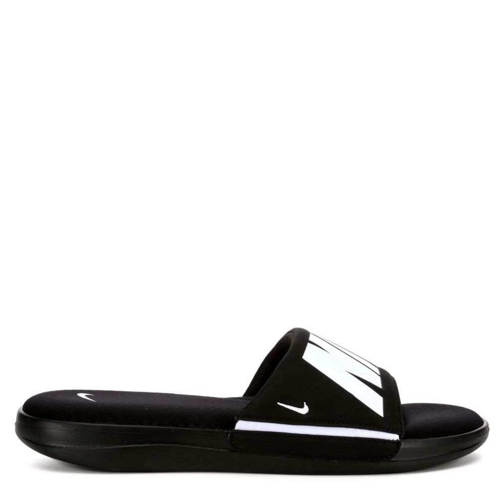 black nike slides with gold check