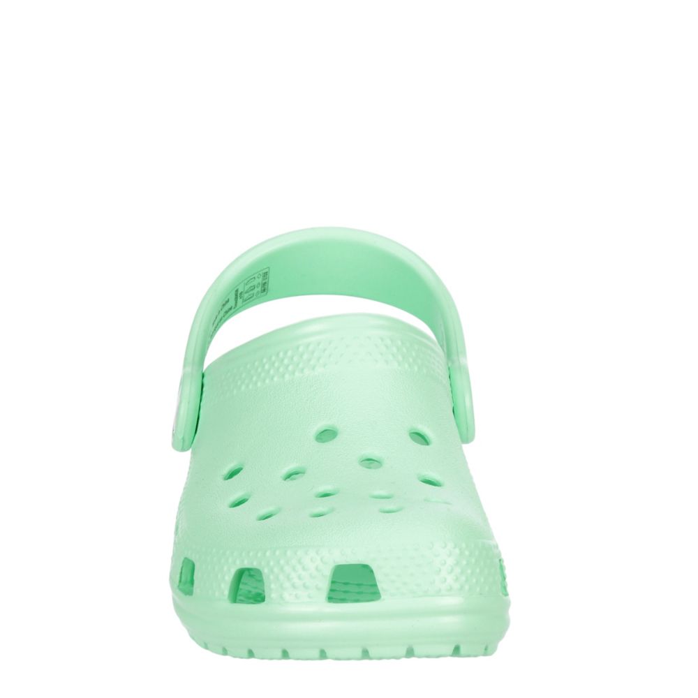 mint green crocs with fur